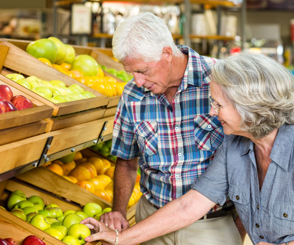Grocery Store Adult Couple Shopping For Fruits | Heritage Waterside Grocery Store