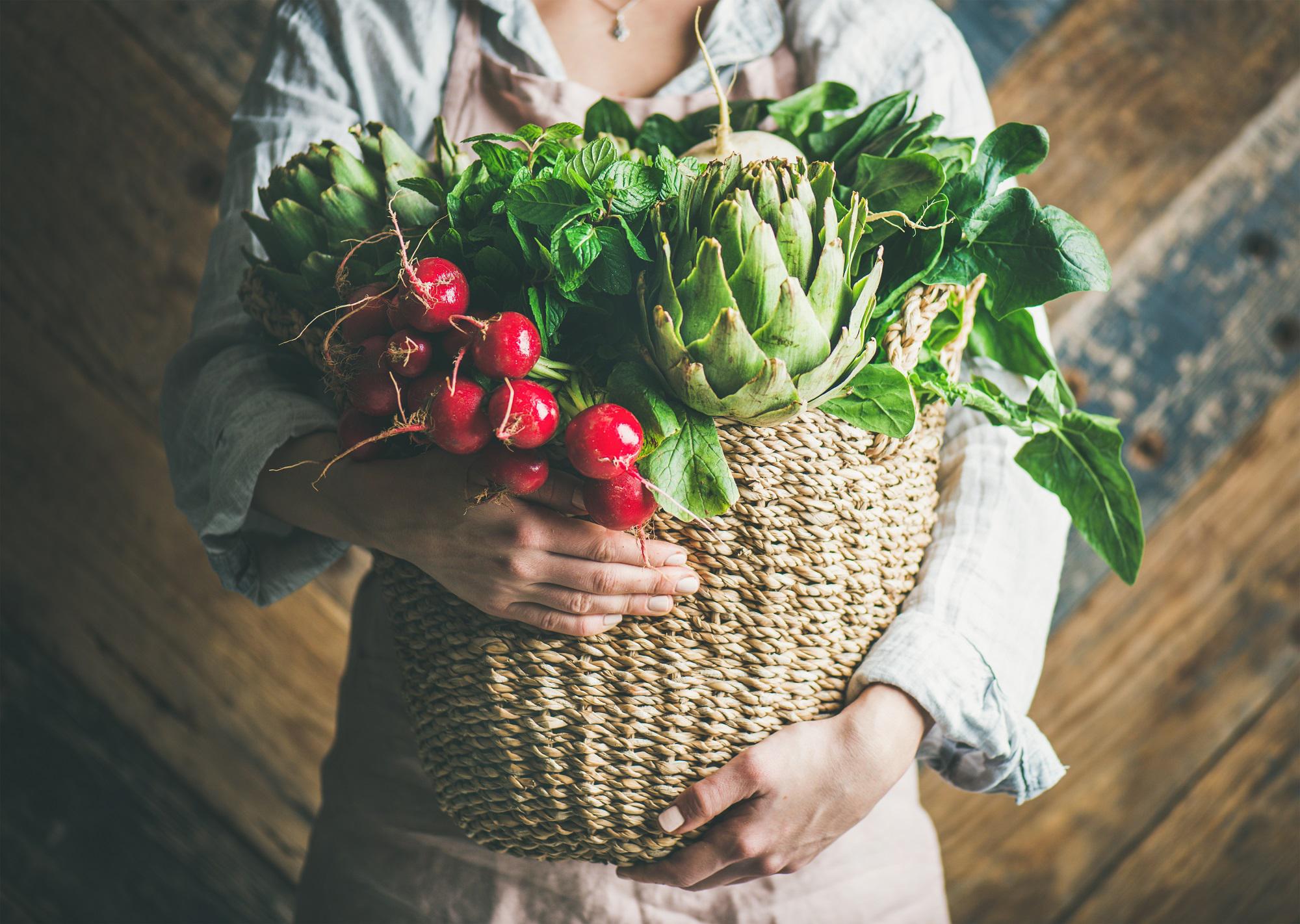 Woman Holding A Basket Of Fresh Seasonal Produce | Bahama Bay