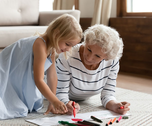 Intergenerational Game Room Grandmother And Granddaughter Coloring Together | Heritage Waterside Intergenerational Learning Rooms